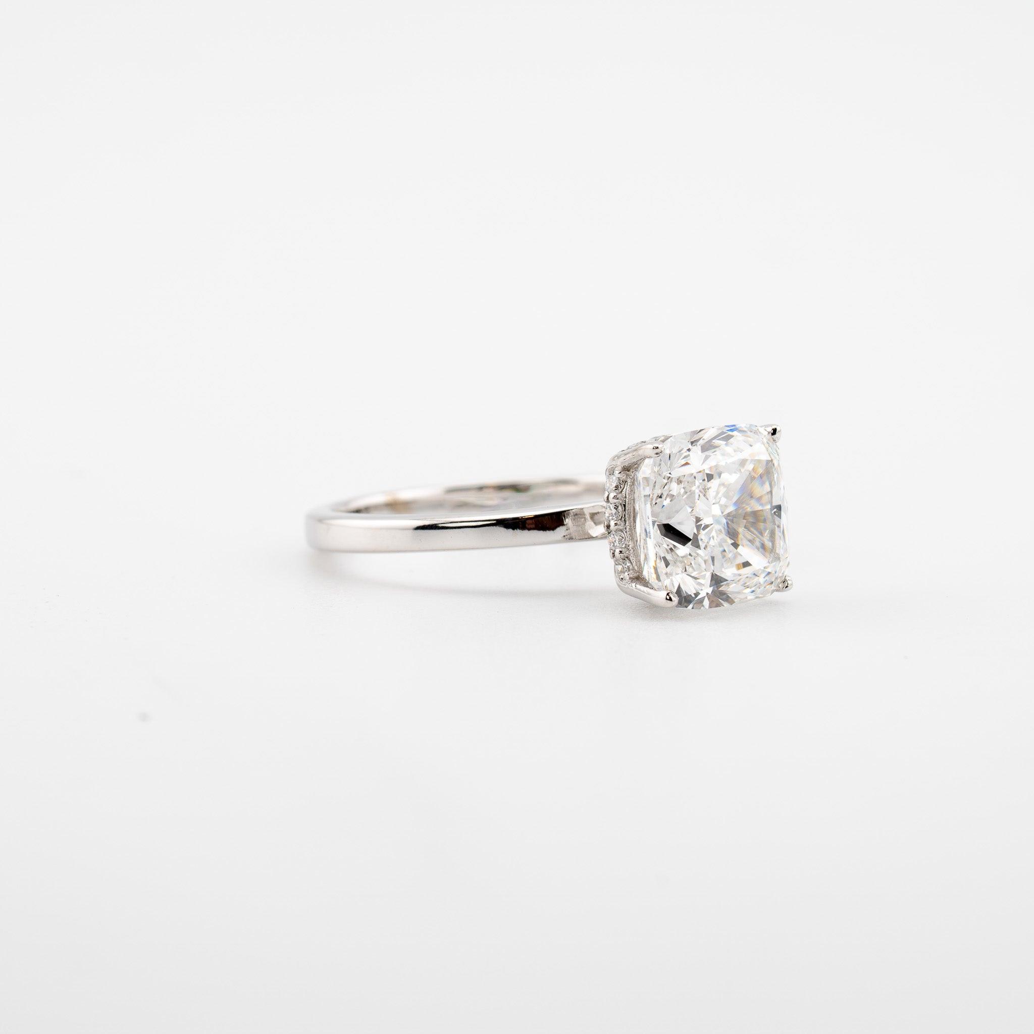 Cushion Cut Engagement Ring in 14kt white gold with a 4.10 ct center stone and side stones.